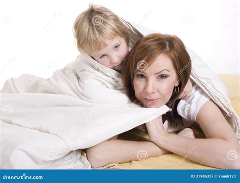 Portrait Of Mother And Daughter Laying In Bed And Smiling Stock Image Image Of Sleeping