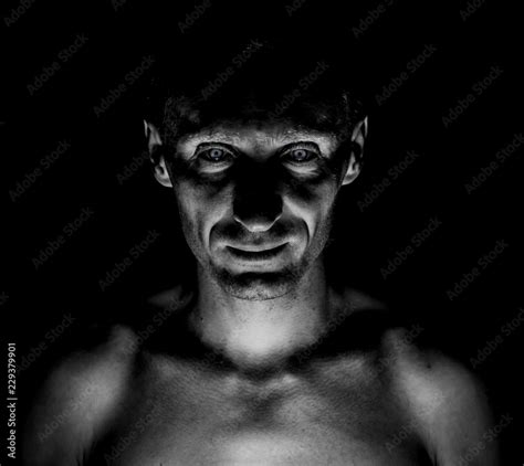Stylish Dark Portrait Of Caucasian Man Who Looks Straight At You And