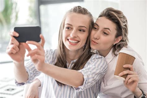 Smiling Girlfriends Taking Selfie On Smartphone At Cafe Stock Image Image Of Casual Pose