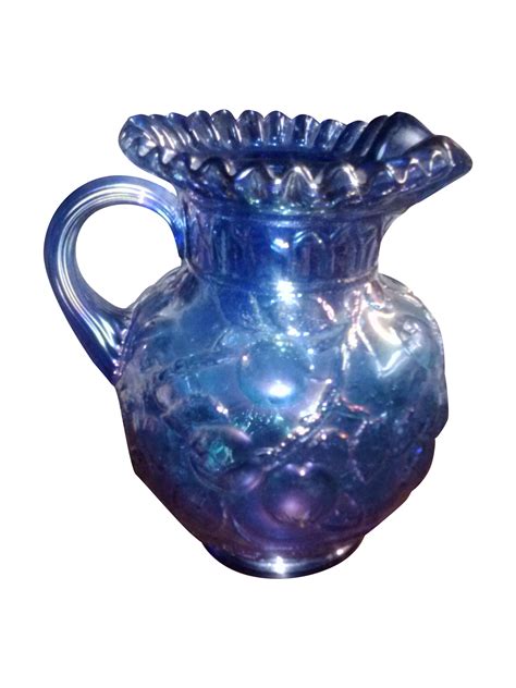 A Blue Glass Vase Is Shown Against A White Background