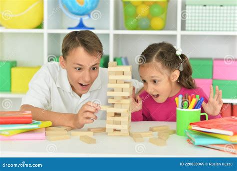 brother and sister playing with wooden blocks at playroom stock image image of home girl