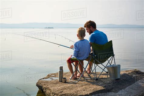 Father And Son Fishing In The River Stock Photo Dissolve