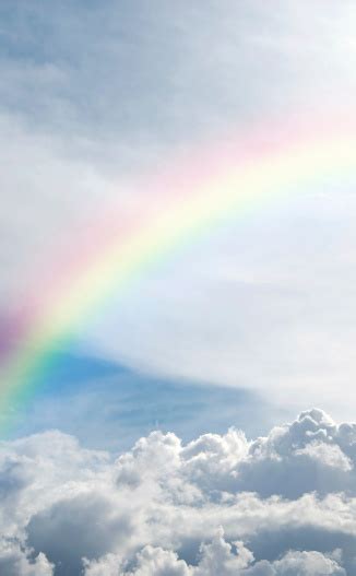 Heavenly Rainbow Shining Above The Clouds Stock Photo