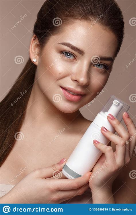 Beautiful Young Girl With Natural Nude Make Up With Cosmetic In Hands