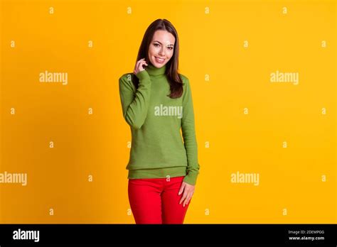 portrait of attractive slender cheerful shy girl wearing casual clothing isolated over bright