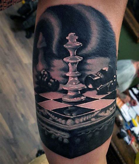 A Mans Arm With A Chess Piece Tattoo On It