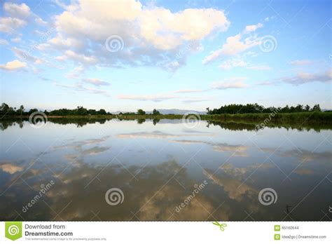 Beautiful Clouds And Blue Sky Reflection On Water Surface Stock Photo