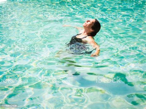 Woman Lying On Clear Water At Tropical Beach Beautiful Mature Girl Lying And Enjoying In Water