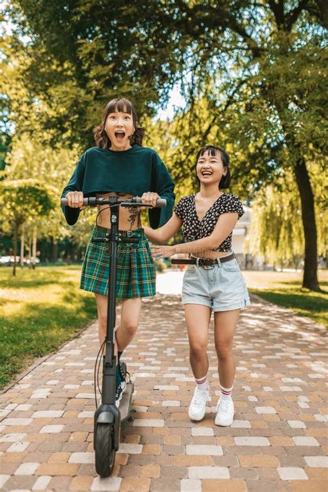 Cute Slim Young Girls Riding A Scooter In The Park Stock Image Image