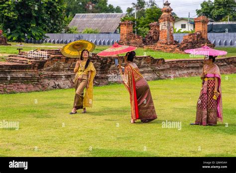 Thai Women In Traditional Dress At The Wat Chai Watthanaram Temple In Ayutthaya Thailand