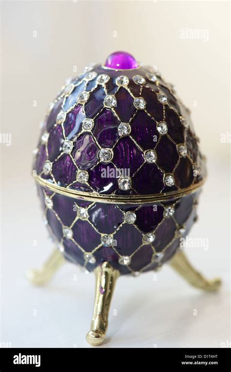 A Diamond Encrusted Purple Faberge Egg In High Key Photographic Style