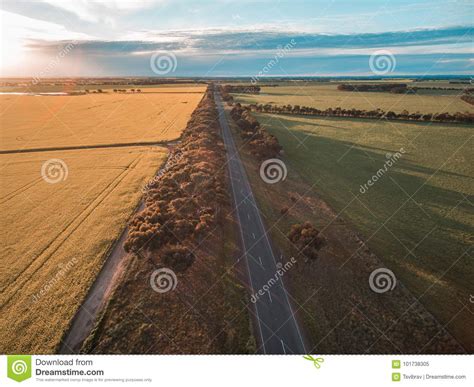 Aerial View Of Rural Road Passing Through Agricultural Land In