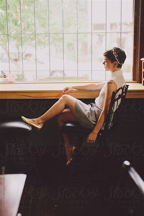 Girl Sitting At A Wine Bar By A Window By Gabrielle Lutze Stocksy United