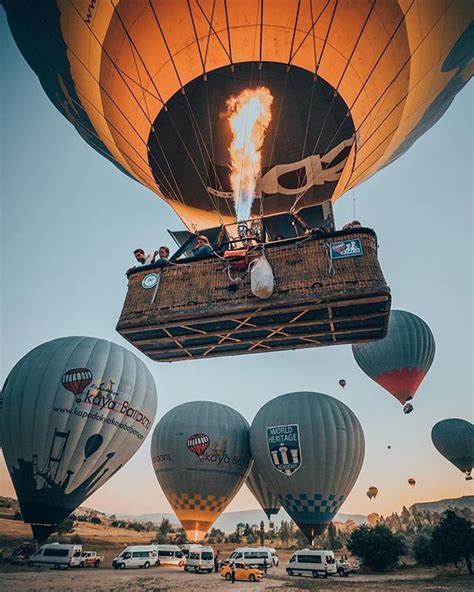 Several Hot Air Balloons Are Being Lifted Into The Sky By People In