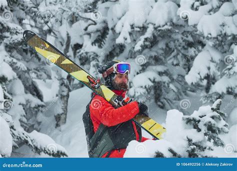 Portrait Young Man Ski Goggles Holding Ski In The Mountains Stock Photo