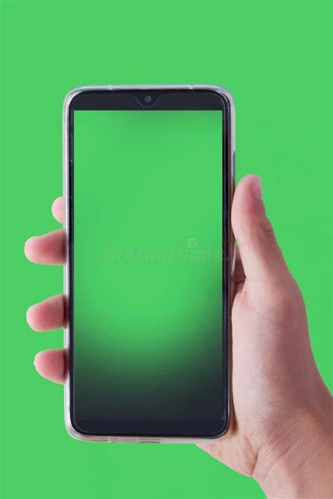 Mobile Phone With A Green Screen In A Male Hand On A Green Background