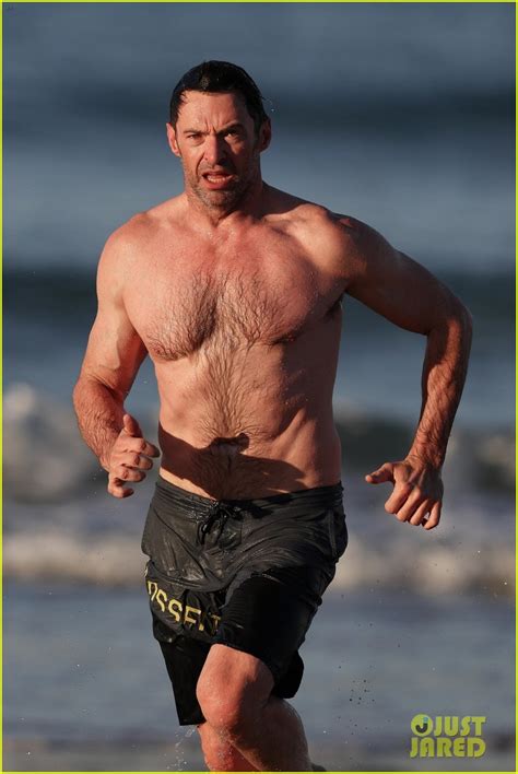 Hugh Jackman Runs Shirtless On The Beach With His Ripped Muscles On