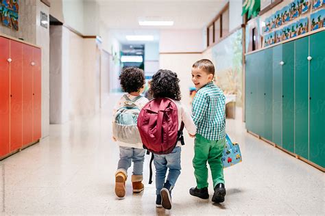 Happy Kids Walking In School Corridor By Stocksy Contributor Sergio