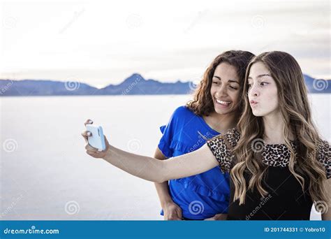 Two Cute And Diverse Teenage Girls Posing And Taking A Selfie Together Outdoors Stock Image