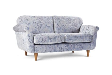 A Blue And White Couch With Wooden Legs