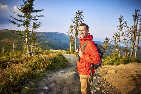 Portrait Of Smiling Man Hiking In The Mountains Stock Photo