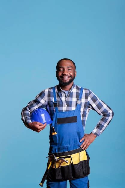 premium photo african american construction worker looking proud at work place holding hard