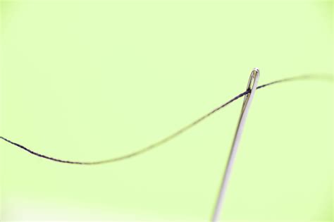 Close Up of Threaded Needle on Green Background-9033 | Stockarch Free ...