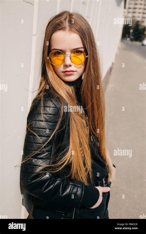 Beautiful Fashionable Kid Girl With Long Hair In Yellow Sunglasses In