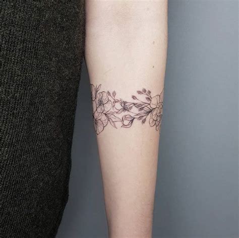 A Woman With A Tattoo On Her Arm