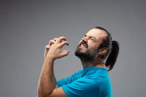 Man Showing Grimace Of Pain With Squeezing Gesture Stock Image Image