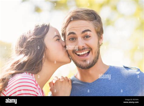 Cute Couple Kissing In The Park Stock Photo Alamy