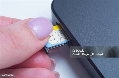 Woman Inserting Sim Card Into Portable Mobile Wifi Router Stock Photo