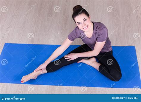 Sporty Woman Doing Stretching Exercises On The Floor Stock Image
