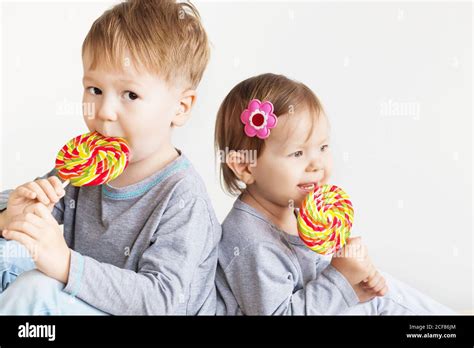 Small kids eating lollipops. Happy children with a big delicious candy