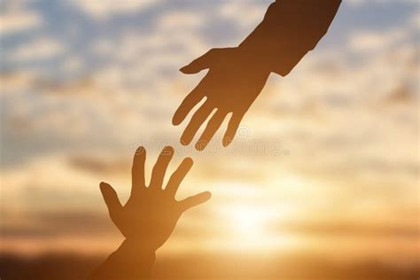 Silhouette Of Giving A Helping Hand Hope And Support Each Other Over