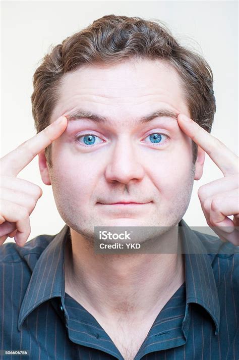 Portrait Of Man Points On His Eyebrows Human Face Parts Stock Photo