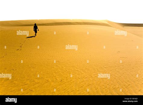 Mauritania Man Walking In The Sahara Desert Stock Photo Alamy