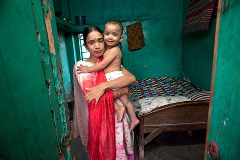 27 Year Old In Bangladesh Holding Her Daughter Fathered By A Client Before Returning To Work At