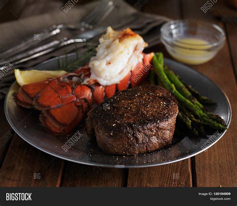 Lobster is more of a novelty food, a good excuse to put on a bib and eat drawn butter. steak and lobster dinner in low key lighting Stock Photo & Stock Images | Bigstock