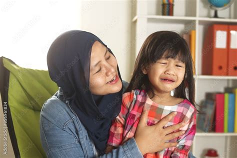 Asian Muslim Mother Hijab Calming Her Sad And Crying Daughter Single