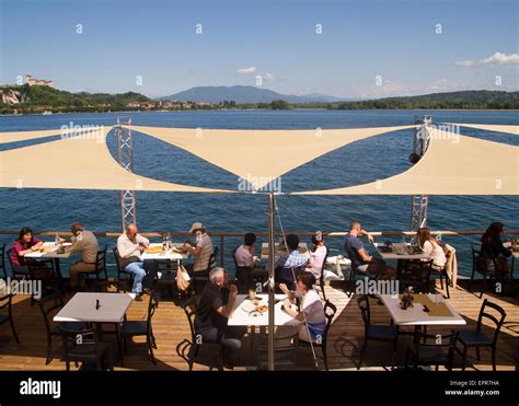 Diners Eating At A Lakeside Restaurant In Arona Lake Maggiore Italy