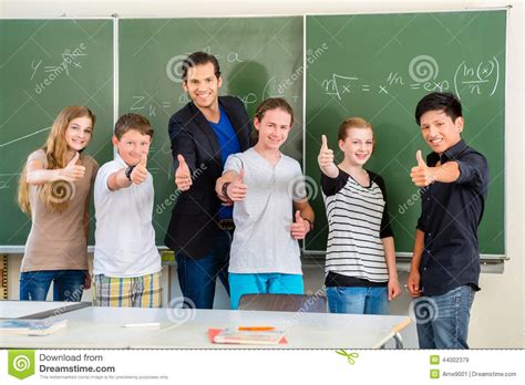 Teacher Motivating Students In School Class Stock Image