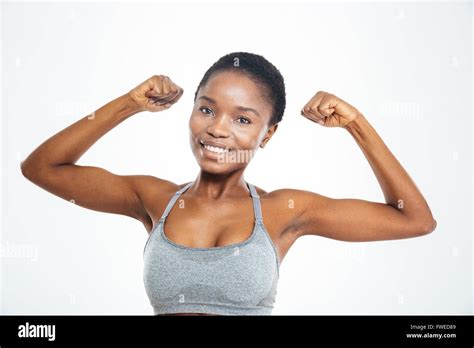 Smiling Afro American Woman Showing Her Biceps Isolated On A White