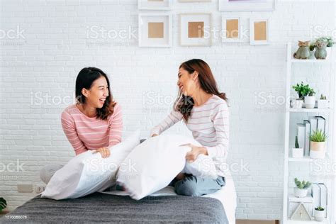 Two Pretty Best Friends Forever Girlfriend Talk Hug And Laugh Together On Bed At Cozy Home