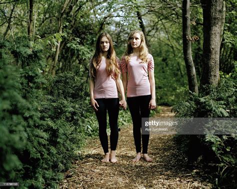 Two Girls In Identical Outfits Holding Hands Photo Getty Images