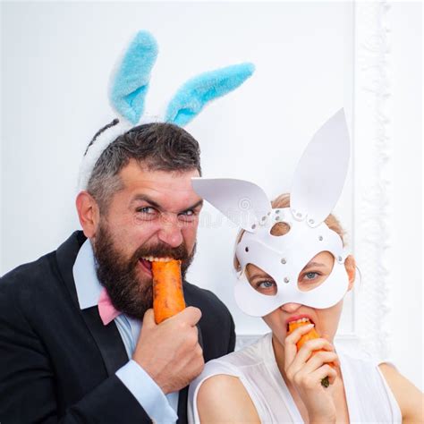 Surprised Bunny Couple Wearing Bunny Ears And Eat Carrot Easter Stock