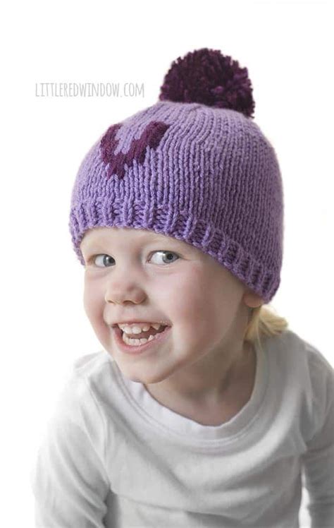 Little Girl Smiling And Wearing Purple Letter V Monogram Hat Hat