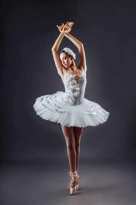 A Young Graceful Ballerina Dressed In Professional Attire Pointe Shoes