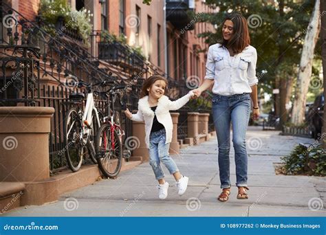 Mother And Daughter Walking Down The Street Stock Photo Image Of