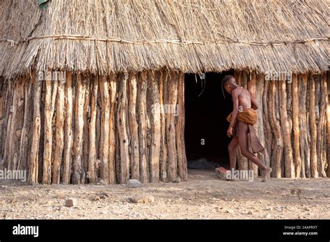 A Kid Walks Into A Hut In A Himba Tribal Village In Namibia Africa